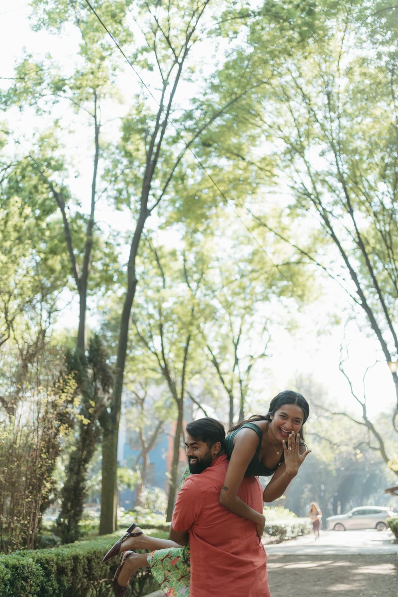 Pooja on Nish's back, laughing
