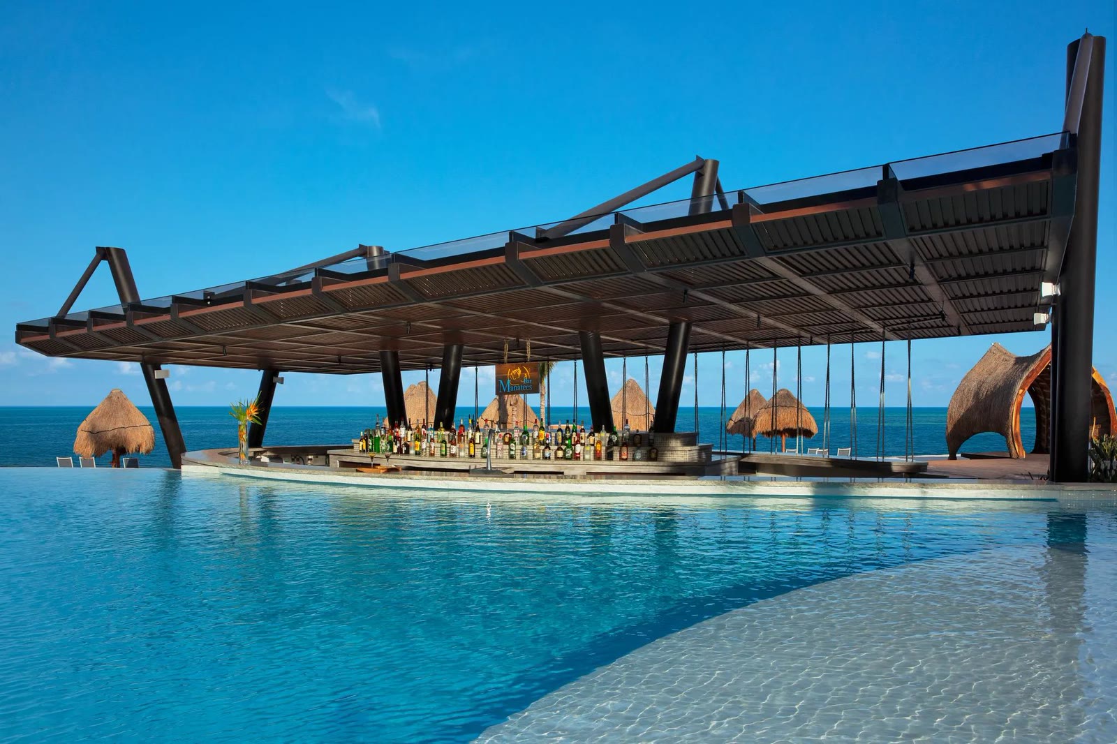 The infinity pool and swim-up bar at Dreams Natura, looking out to the sea